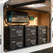 Renogy 23.04kWh off-grid power kit inverter and six 300Ah batteries installed in a caravan storage locker