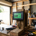 Renogy 500A battery monitor mounted on a timber workbench bracket inside a shed mid-fitout