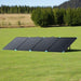 Renogy 400W portable solar panel angled on grass field.
