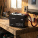 Renogy 48V 50Ah battery wired into a shed off-grid system beside a hybrid inverter and DC breaker panel
