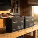Two Renogy 48V 50Ah batteries wired in parallel on a shed workbench beside an inverter