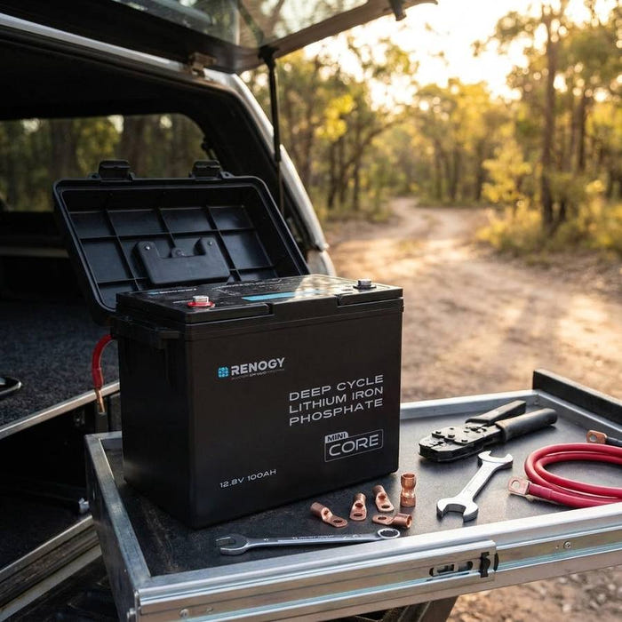 Renogy Core Mini 100Ah battery in an open battery box in a 4WD canopy drawer, tailgate open to a bush track