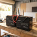 Two Renogy Core Mini 100Ah batteries wired in parallel on a shed workbench