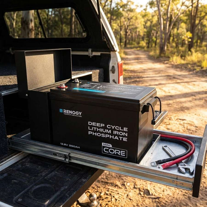 Renogy Core Mini 200Ah battery in an open battery box in a 4WD canopy drawer, tailgate open to a bush track