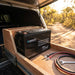 Renogy Core Mini 300Ah battery in an open battery box in a 4WD canopy drawer, tailgate open to a bush track