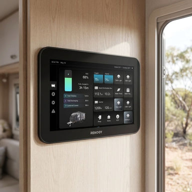 Renogy ONE Vision 7 flush mounted in a caravan wall beside the door with Australian bush visible outside