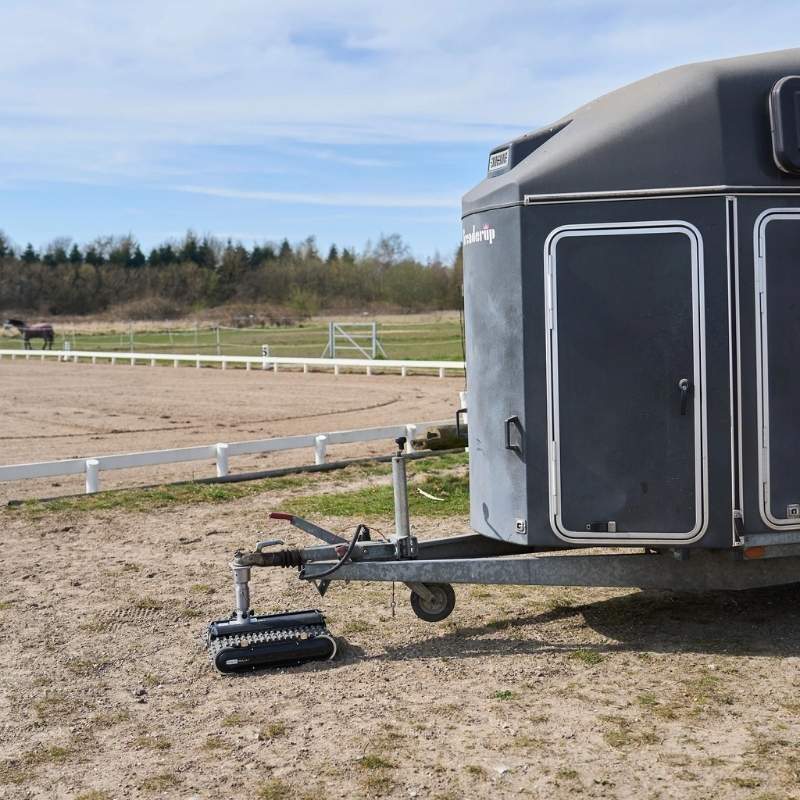 Robot Trolley 1500RS G5 Caravan Mover operating on gravel terrain with a caravan attached