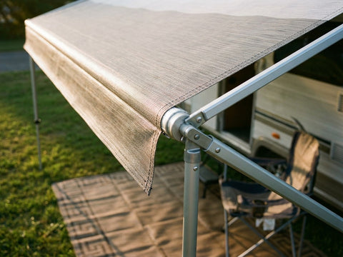 A caravan with its awning out at a coastal campground
