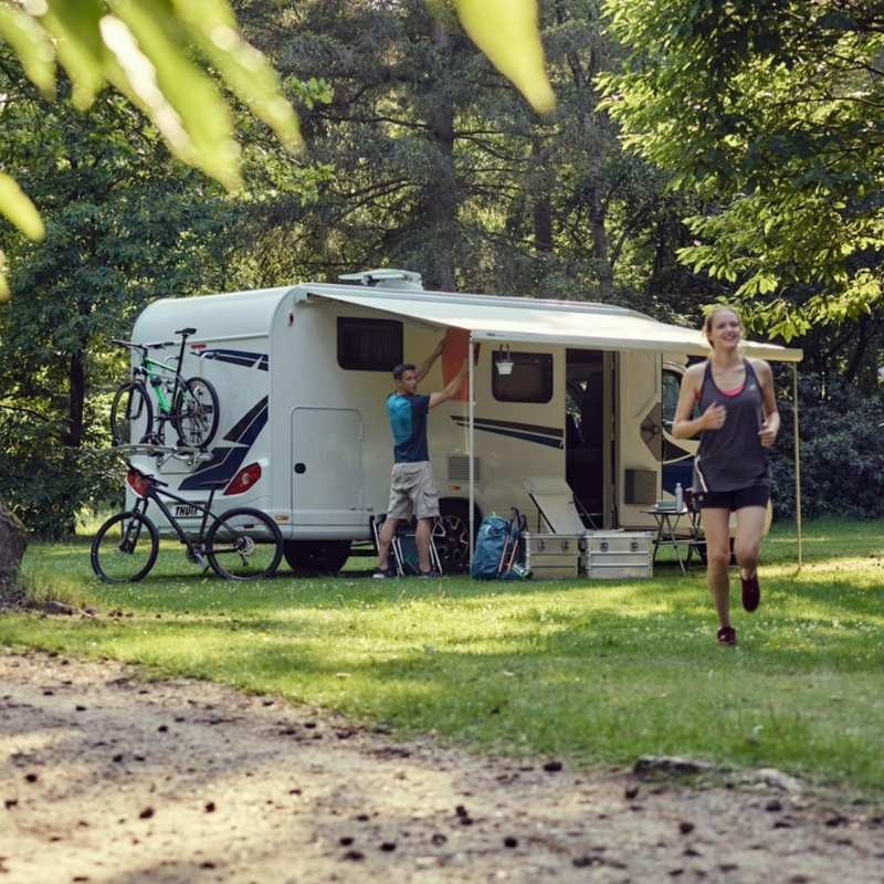 A complete camping setup with the Thule Omnistor 5200 Electric 12V awning providing shade and comfort for outdoor enthusiasts.