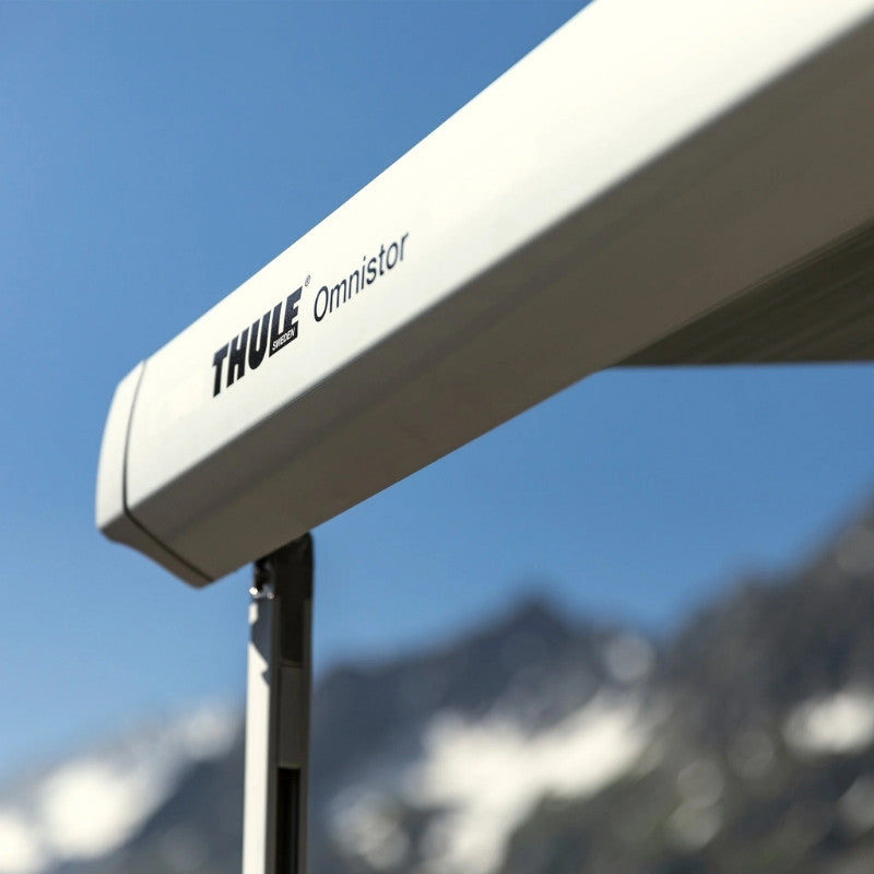 Close-up view of the Thule Omnistor 5200 Electric 12V awning cassette mounted on a vehicle with a clear sky in the background.