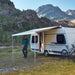 Thule Omnistor 6300 Electric 12V Awning deployed on a camper van in a breathtaking mountain landscape, offering shade and comfort in the great outdoors.